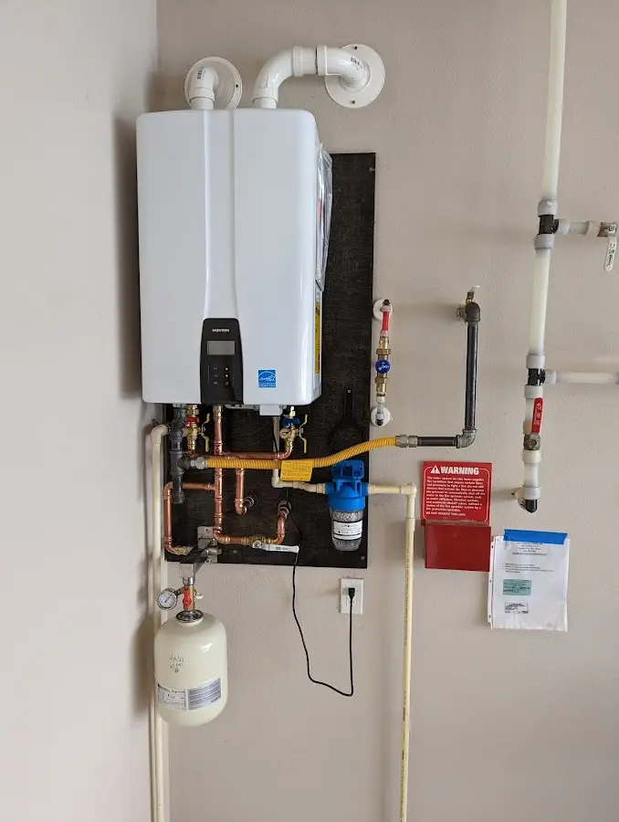 Professional plumber installing copper piping in a South Salt Lake home